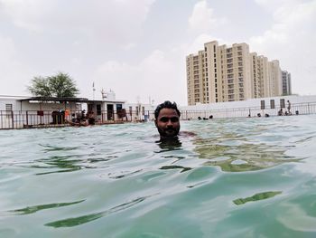 Portrait of young man swimming in pool