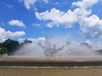 View of fountain against cloudy sky