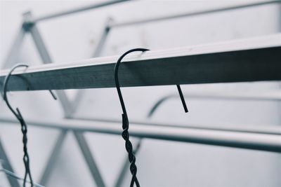 Close-up of hooks on metal rod