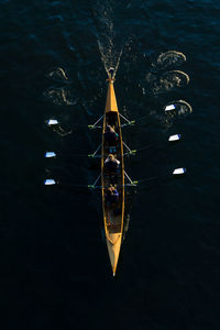 Aerial view of people kayaking in sea 