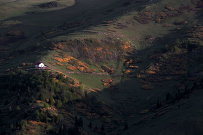 Wooden bungalow is on the top of hill at sunset