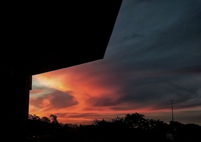 Low angle view of silhouette trees against sky at sunset