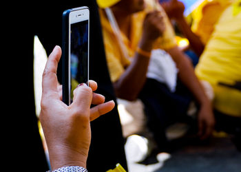 Cropped hands of woman using phone