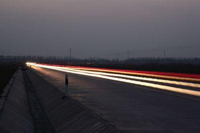 Light trails on road in city at night