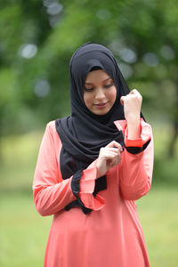 Young woman standing against blurred background