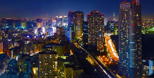 Aerial view of illuminated buildings in city at night