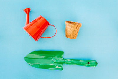 High angle view of gardening equipment on blue background