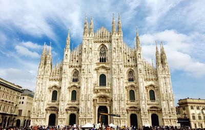 People at milan cathedral against sky