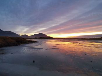 Scenic view of beach against sky during sunset