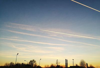 Vapor trail against sky during sunset