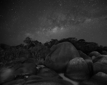 Scenic view of rocks against sky at night