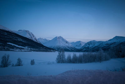 Scenic view of snowcapped mountains against clear blue sky