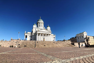 Low angle view of historical building against clear blue sky