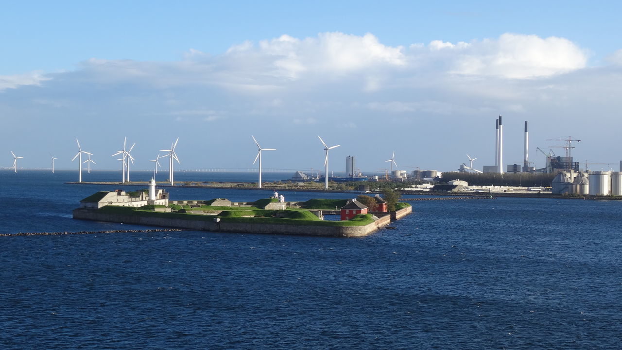 BOATS MOORED IN RIVER AGAINST SKY