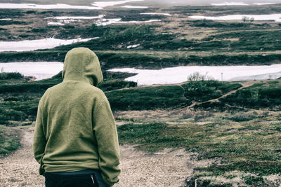 Rear view of man standing on land