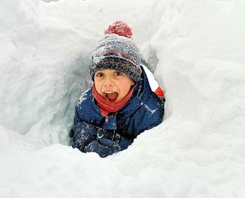 High angle view portrait of boy in snow