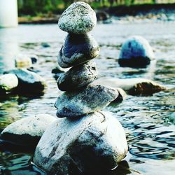 Close-up of stone stack on rock in water