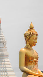 Statue of buddha against building