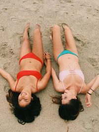 High angle view of woman lying on sand