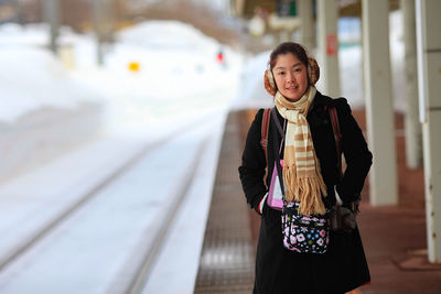 Portrait of young woman standing outdoors