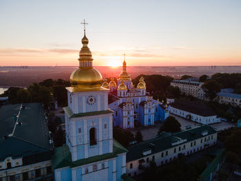 Buildings against sky during sunset in city