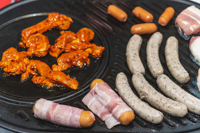 High angle view of meat on barbecue grill