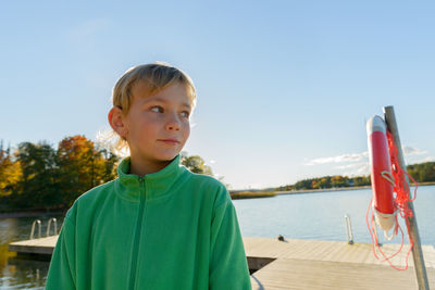 Portrait of boy on shore against sky