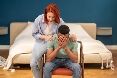 Unhappy diverse couple discussing divorce at home, solving marriage problems