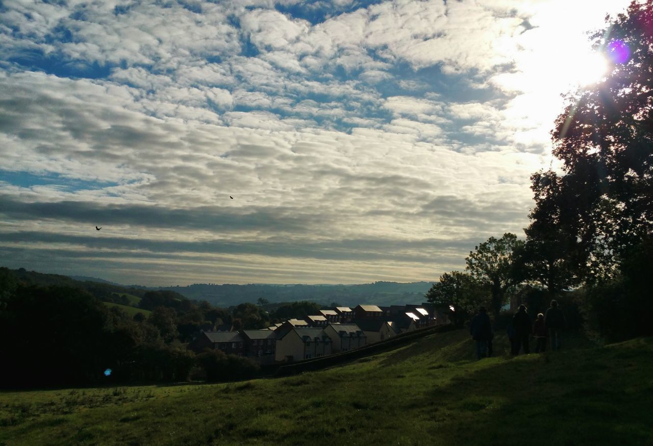 HOUSES ON LANDSCAPE AGAINST SKY