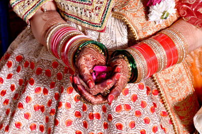 Midsection of woman with henna tattoo