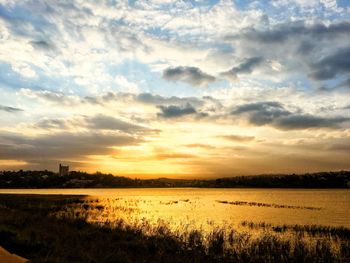 Scenic view of field against sky during sunset