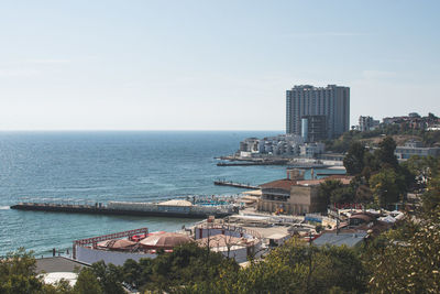 High angle view of buildings by sea against sky