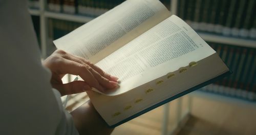 Midsection of woman reading book