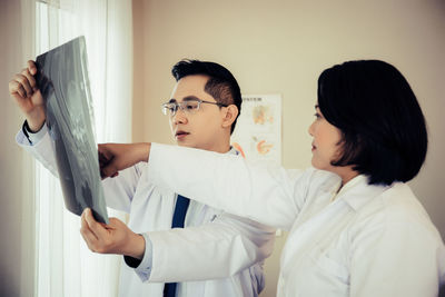 Doctors analyzing x-ray at hospital