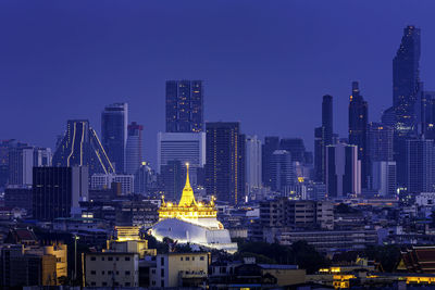 Illuminated buildings in city at night