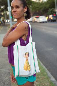 Side view of woman standing by street