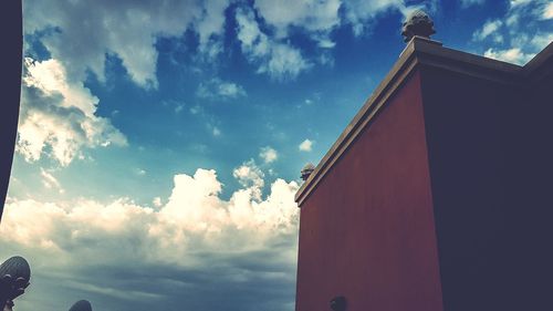 Low angle view of building against cloudy sky