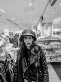 Portrait of young woman with hat standing at supermarket