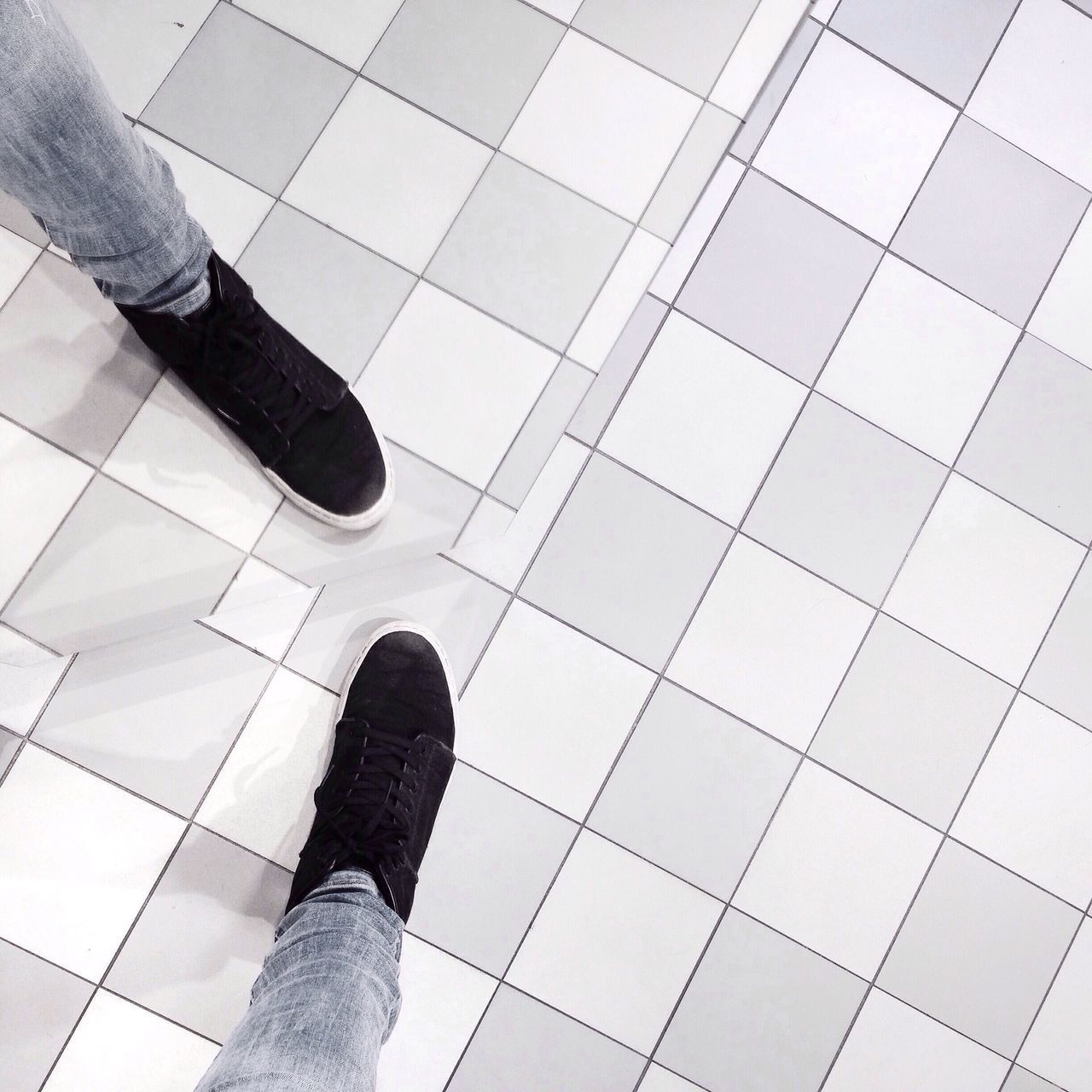 low section, person, shoe, high angle view, modern, low angle view, personal perspective, tiled floor, part of, reflection, lifestyles, standing, men, unrecognizable person, human foot, pattern, flooring