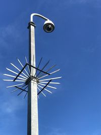 Low angle view of cctv street light and camera against sky