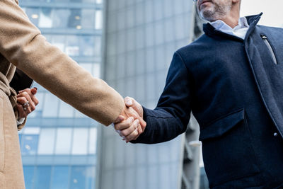 Midsection of businessman holding hands