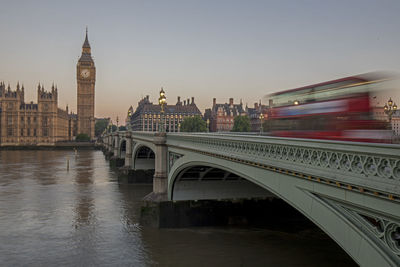 Tower bridge over thames river against clear sky during sunset