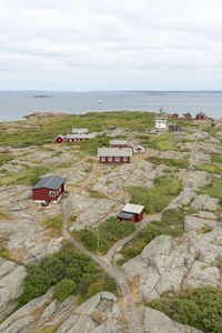 High angle view of buildings by sea against sky