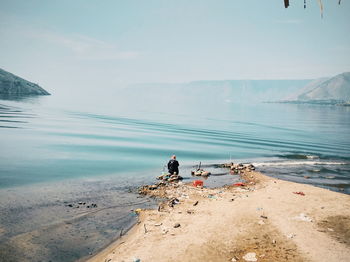 Man on beach against sky