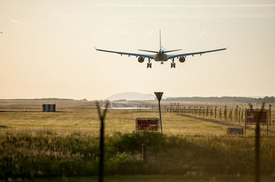 Airplane flying over field