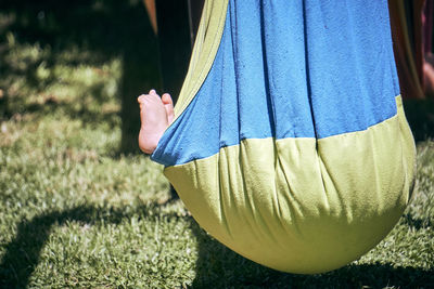 Low section of woman standing on field