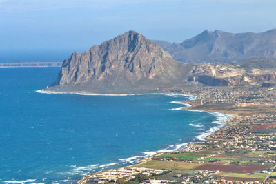 Scenic view of sea and mountains against sky
