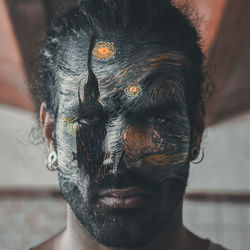 Close-up portrait of man with face paint