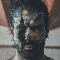 Close-up portrait of man painting