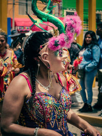 Woman dancing in traditional clothing during festival